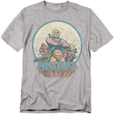 Grey Masters of the Universe t-shirt featuring He-Man standing proudly with Battle Cat and Orko, with Castle Grayskull in the background and the bold MOTU logo below.