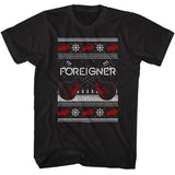 Black t-shirt featuring a knit-style Foreigner design with crossed red guitars, snowflakes, and holiday sweater patterns.