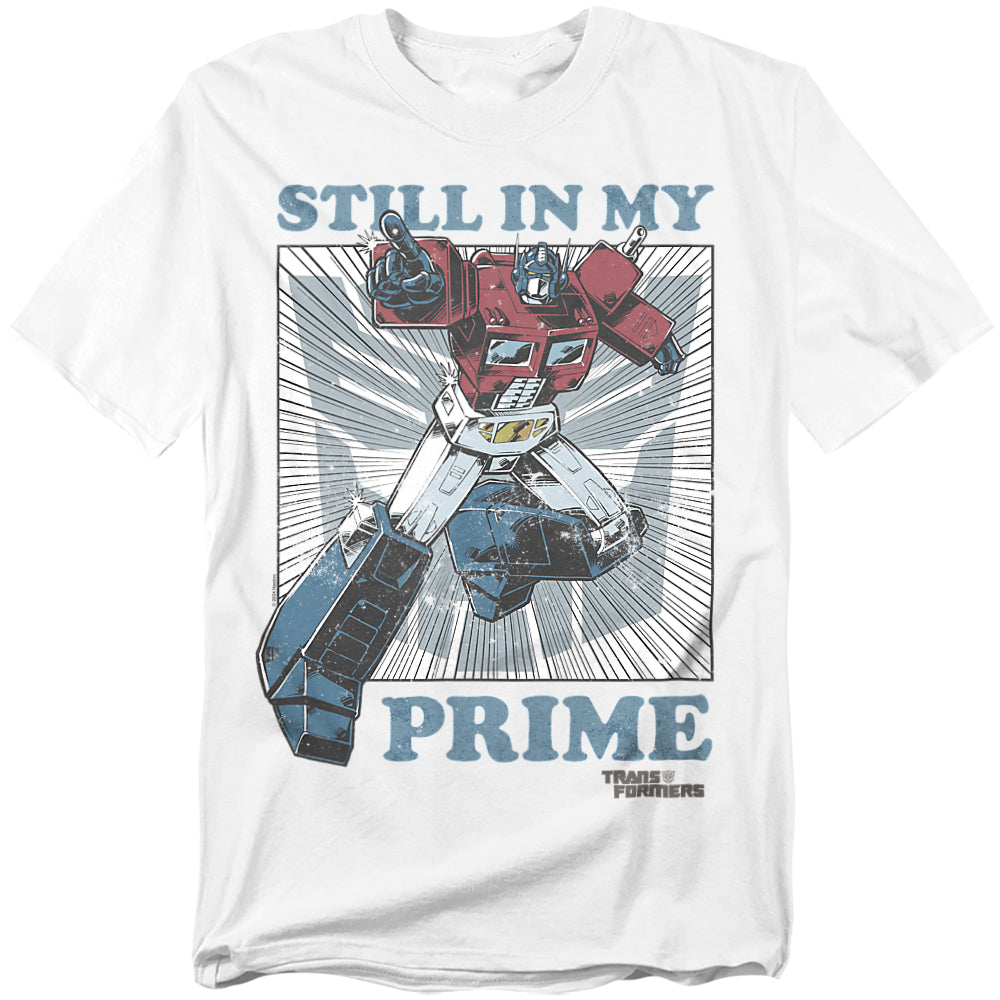 White t-shirt featuring Optimus Prime in a comic-style action pose with the words “Still in My Prime” in bold lettering.