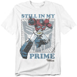 White t-shirt featuring Optimus Prime in a comic-style action pose with the words “Still in My Prime” in bold lettering.