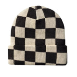 Black and white checkered beanie on a light beige background