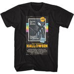 Black T-shirt featuring a vintage VHS-style design of John Carpenter’s Halloween with Michael Myers and the tagline “The trick is to stay alive.”
