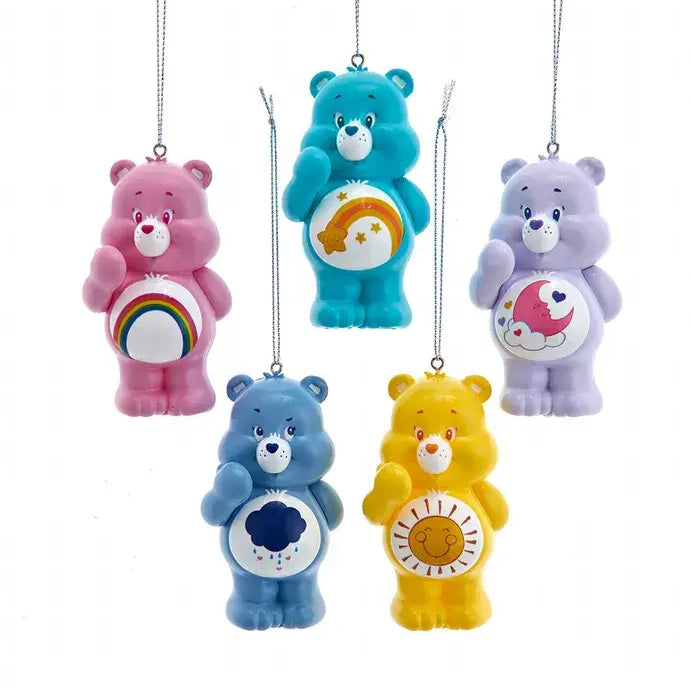 Set of five colorful Care Bears ornaments, each with different belly badges, hanging from silver strings.