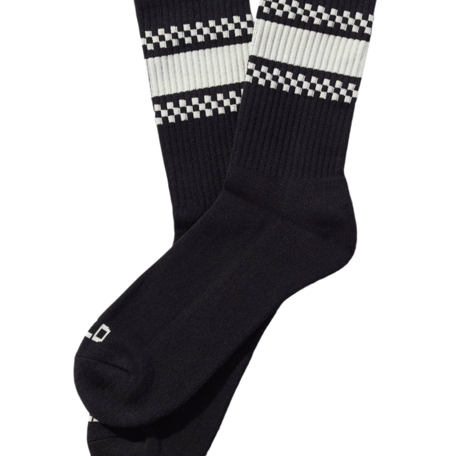Black socks with white checkered patterns on a beige background