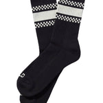 Black socks with white checkered patterns on a beige background