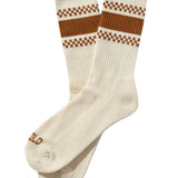 White socks with brown checkered stripes on a beige background