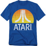 Blue t-shirt featuring the Atari logo in white over a retro sunset gradient circle of orange and yellow, with a distressed vintage effect.