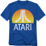 Blue t-shirt featuring the Atari logo in white over a retro sunset gradient circle of orange and yellow, with a distressed vintage effect.