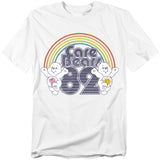 White t-shirt featuring Care Bears with a rainbow and “Care Bears 82” graphic in retro lettering.