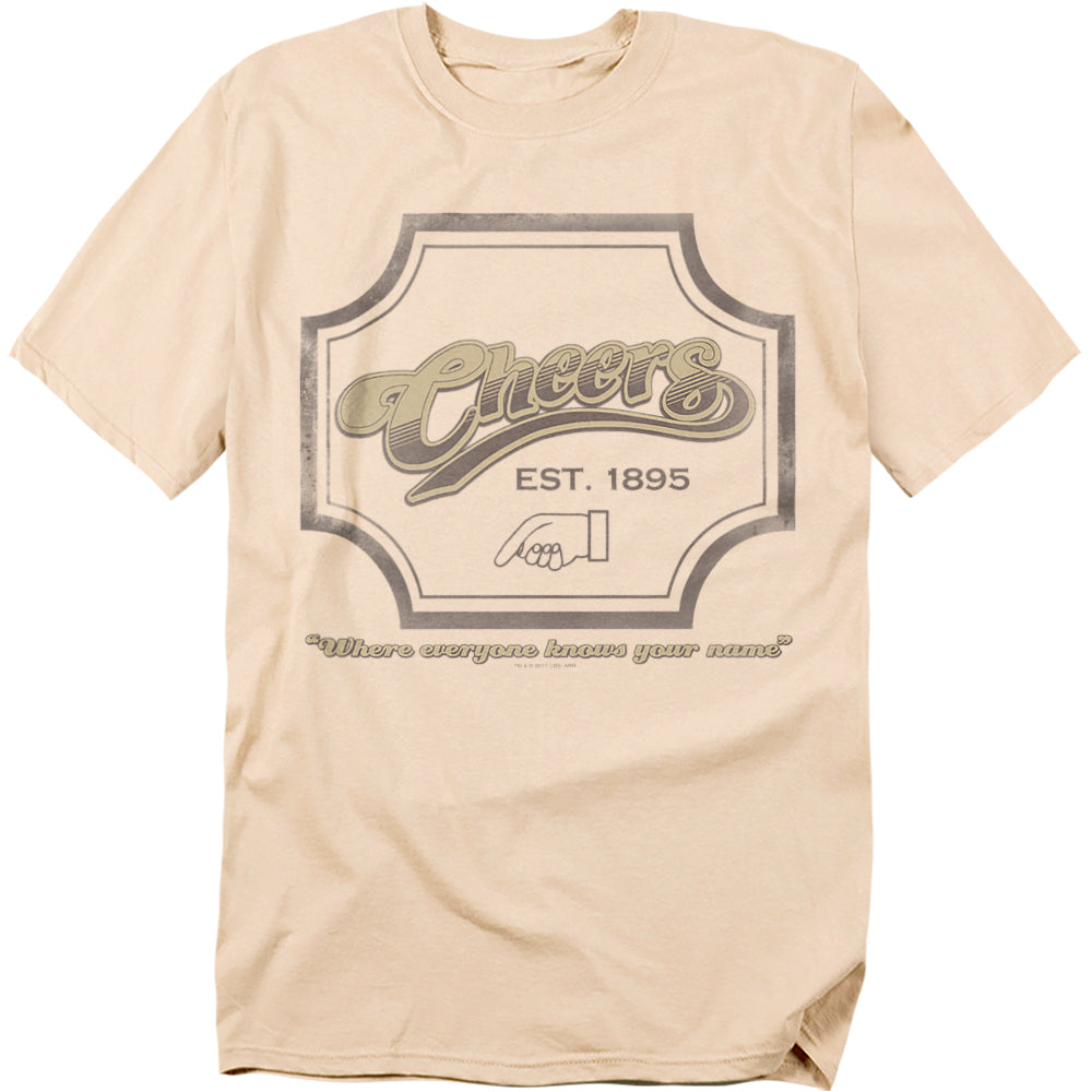 Beige t-shirt with Cheers logo, “Est. 1895,” a handshake emblem, and the phrase “Where everyone knows your name.”