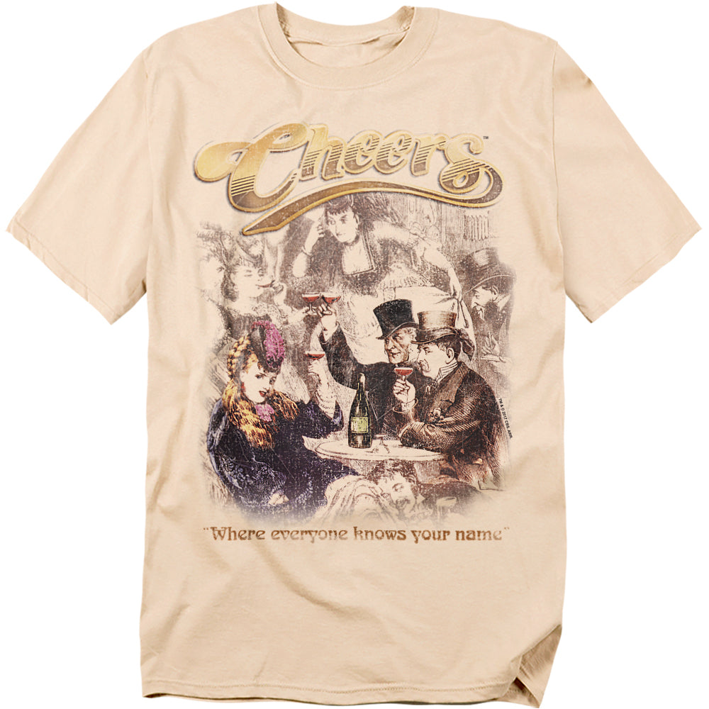 Beige t-shirt with vintage tavern illustration, golden Cheers logo, and the phrase “Where everyone knows your name.”
