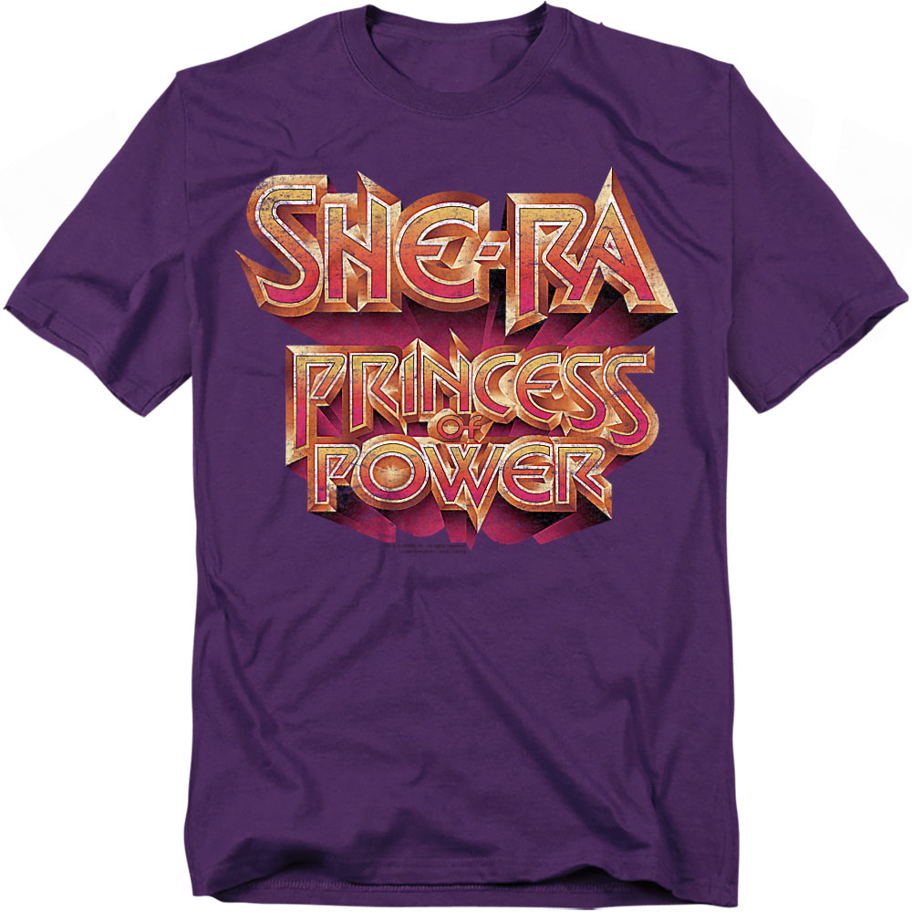 Purple She-Ra t-shirt featuring the bold retro logo “She-Ra Princess of Power” in large golden letters with a shimmering metallic look.