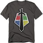 A charcoal gray t-shirt featuring the Voltron crest emblem. The design shows a black sword silhouette forming the center, divided into four colored quadrants: red, green, blue, and yellow. The colors represent the lion force that forms Voltron, with a distressed texture for a vintage look.