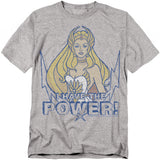 A gray t-shirt featuring She-Ra from She-Ra: Princess of Power. She is illustrated with long blonde hair, a white costume, and a golden tiara. Below her, bold distressed blue text reads “I HAVE THE POWER!” with lightning bolt graphics surrounding the design.