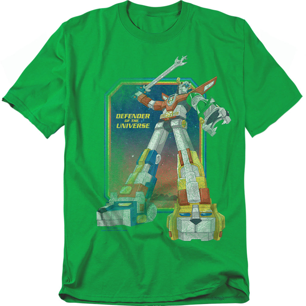 A green t-shirt featuring Voltron in his full combined form, holding his blazing sword high. The artwork shows the giant robot with his lion limbs in bold colors against a cosmic background. Beside him, the text reads “Defender of the Universe” in yellow.