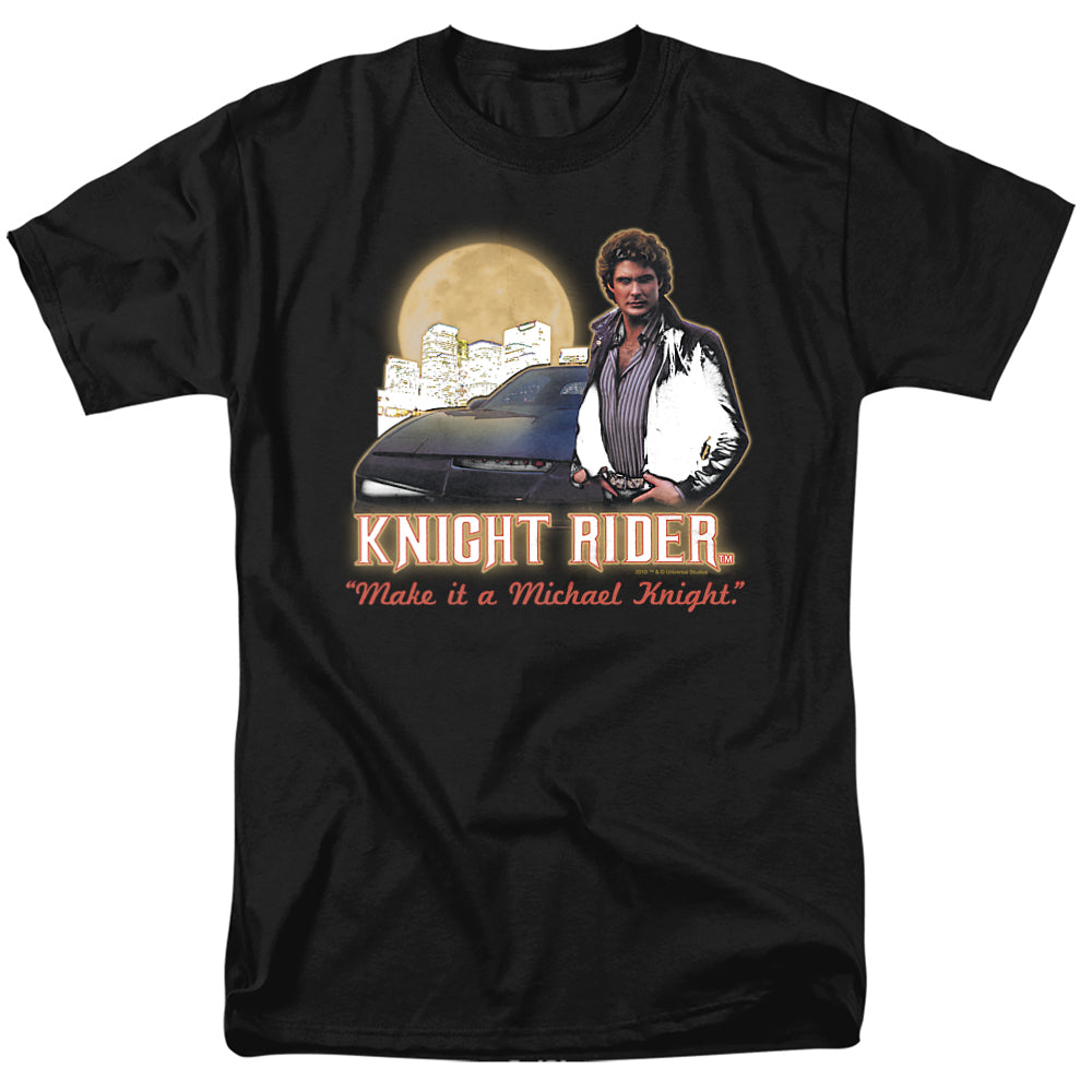 Black t-shirt featuring Michael Knight (David Hasselhoff) with KITT, city skyline, full moon, and the text “Knight Rider – Make it a Michael Knight.”