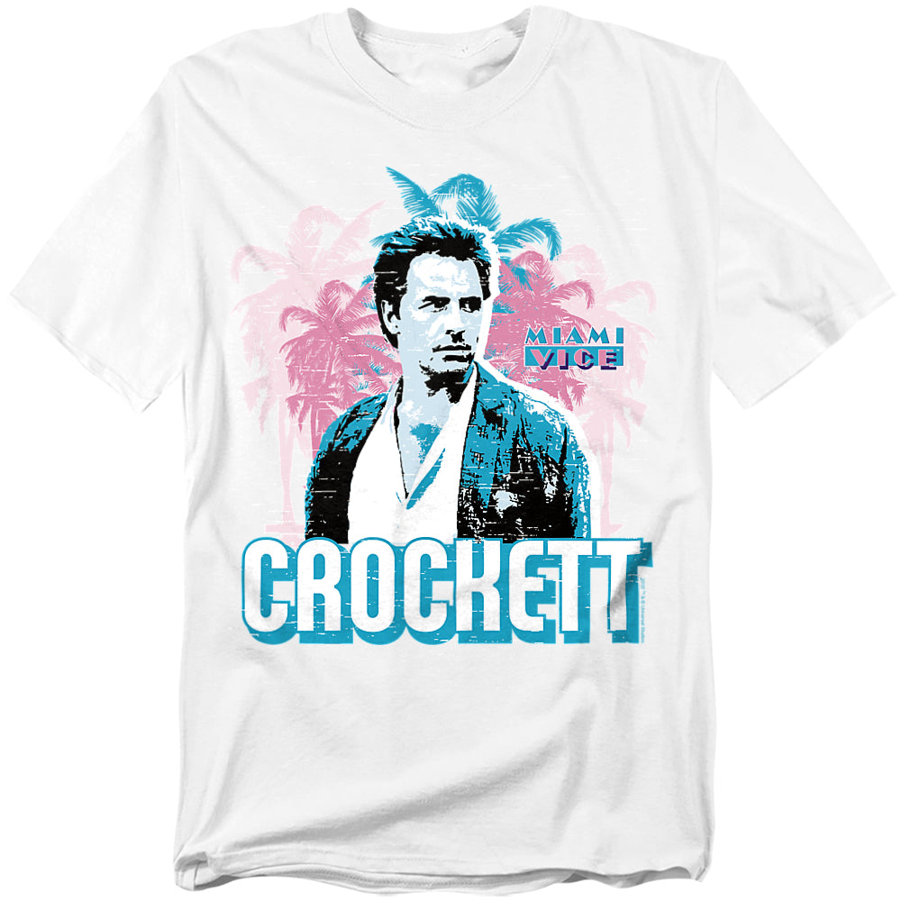White t-shirt featuring Sonny Crockett from Miami Vice in his signature pastel style, with neon palm trees and bold “CROCKETT” lettering beneath him.