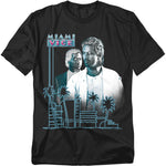 Black t-shirt featuring Crockett and Tubbs from Miami Vice with a neon pink and blue skyline, palm trees, and retro logo.