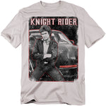 T-shirt featuring a black-and-white image of David Hasselhoff as Michael Knight from the TV series Knight Rider, leaning against KITT with arms crossed, distressed style with bold red “Knight Rider” text above.
