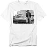 White t-shirt featuring a black-and-white photo of Michael Knight (David Hasselhoff) leaning against KITT, the iconic Pontiac Trans Am from Knight Rider. The Knight Rider logo appears in the bottom corner.