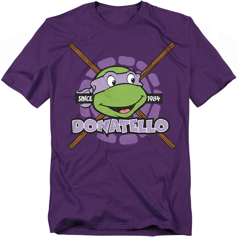 Purple t-shirt featuring Donatello from Teenage Mutant Ninja Turtles with his bo staff and retro 'Since 1984' design.