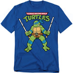 Blue t-shirt featuring Leonardo from Teenage Mutant Ninja Turtles holding twin katanas with retro cartoon artwork.