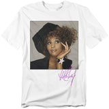 White t-shirt featuring a portrait of Whitney Houston in a stylish hat with her purple autograph printed below.