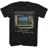Black Poltergeist graphic T-shirt featuring vintage television static artwork and It Knows What Scares You slogan