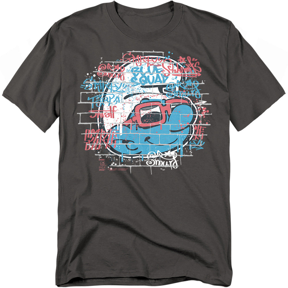 Charcoal t-shirt with graffiti-style Smurf wearing red sunglasses on a brick wall background with colorful spray-paint text.