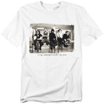 White t-shirt featuring a black-and-white image of The Breakfast Club cast sitting in the school library during detention, with the movie title below.
