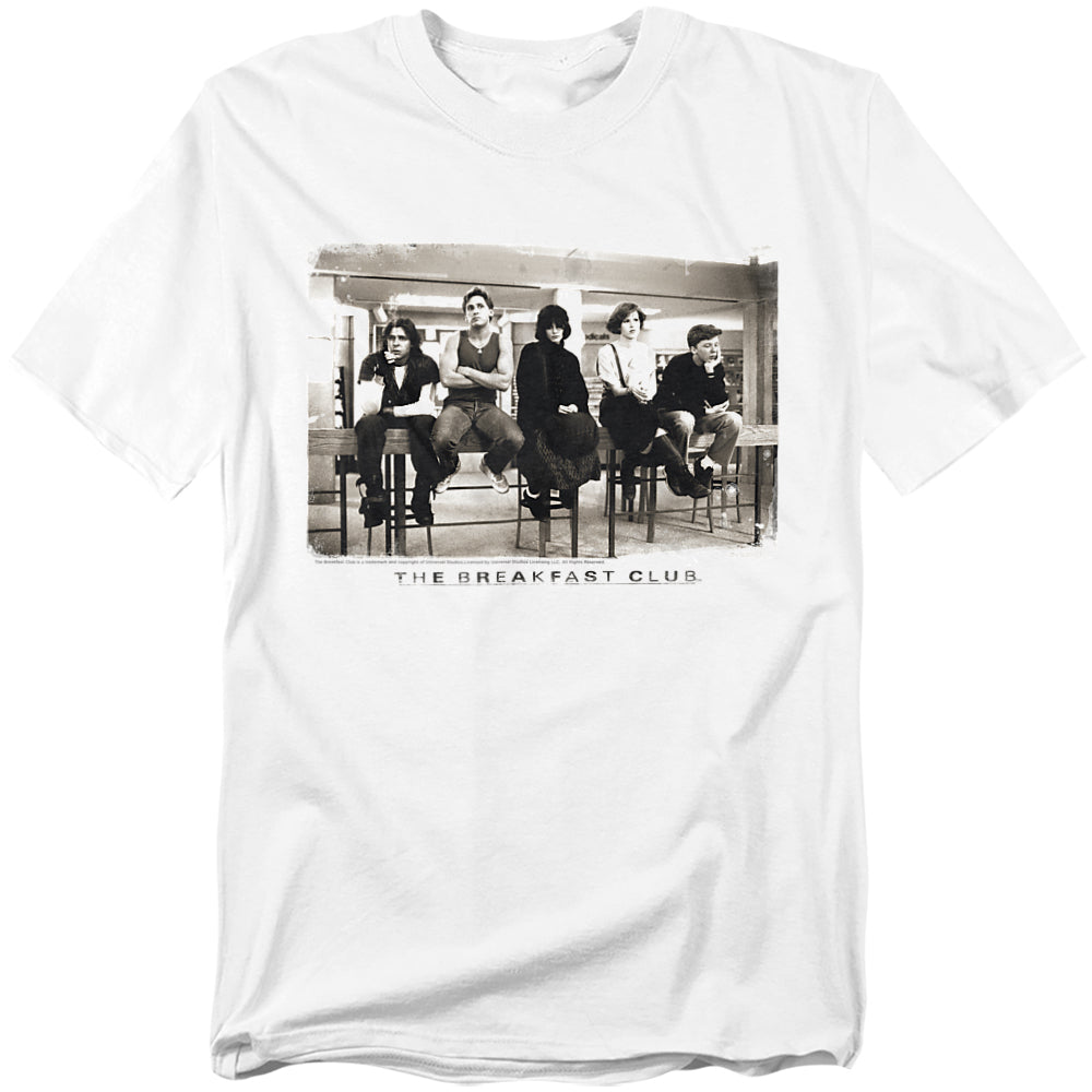 White t-shirt featuring a black-and-white image of The Breakfast Club cast sitting in the school library during detention, with the movie title below.