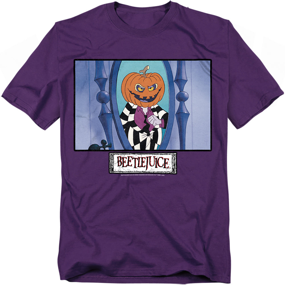 A purple t-shirt featuring Beetlejuice from the animated series. The design shows Beetlejuice with a carved pumpkin head, wearing his iconic black-and-white striped suit and purple shirt, standing in front of a tall mirror with a mischievous grin. The Beetlejuice logo is displayed below in a distressed white box.