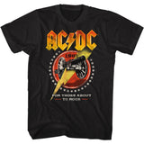 Black AC/DC T-shirt featuring a bold 1981 “For Those About to Rock” cannon design with a large yellow lightning bolt and star-ring emblem.