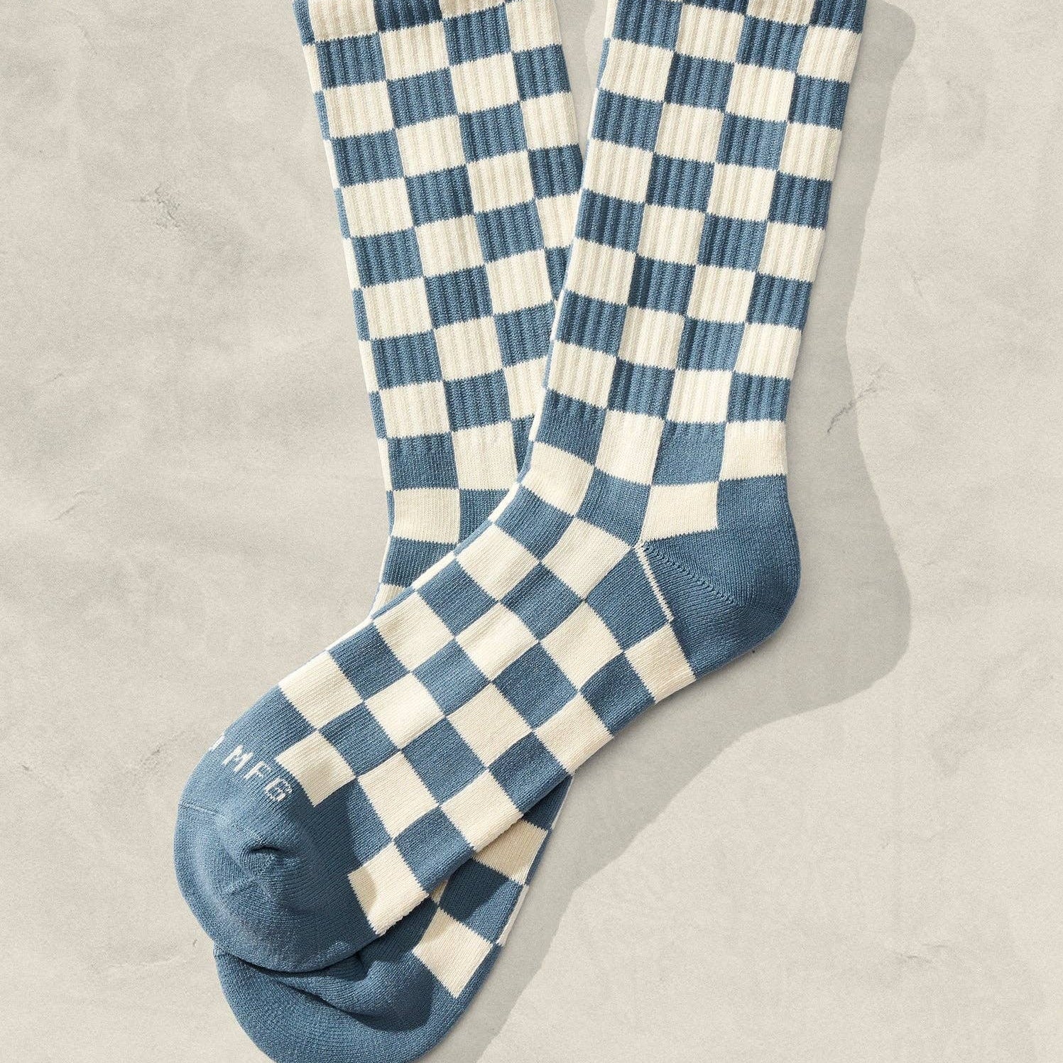 Blue and cream checkered crew socks featuring ribbed knit construction and vintage aesthetic