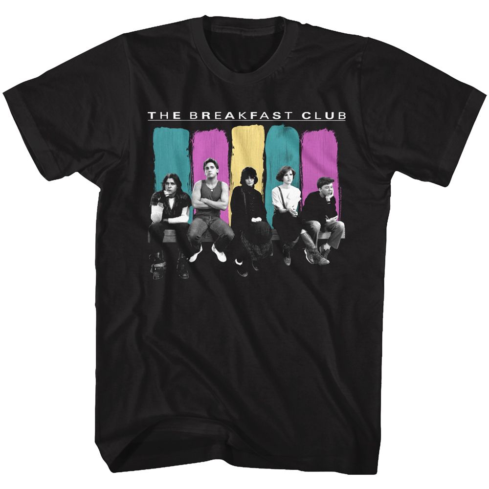 Black T-shirt featuring a black-and-white image of The Breakfast Club cast sitting in a row, backed by teal, yellow, and magenta color-block brushstrokes with “The Breakfast Club” above.