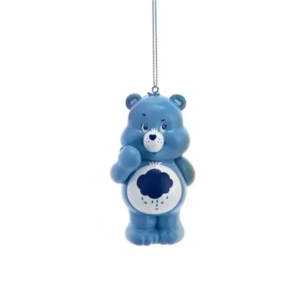 Blue Care Bears Grumpy Bear ornament with storm cloud belly badge hanging from silver string.