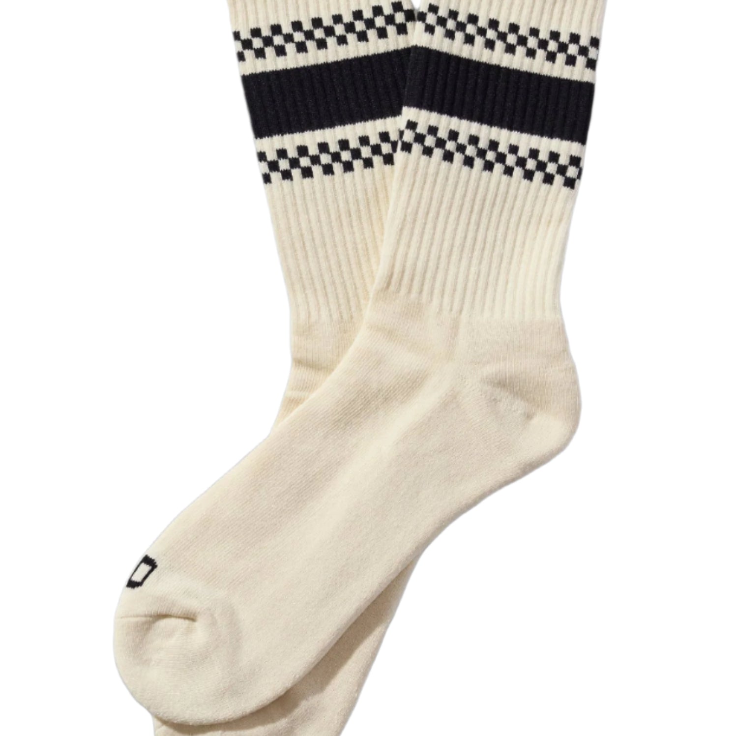 White socks with black and white checkered bands on a beige background