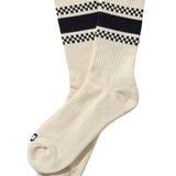 White socks with black and white checkered bands on a beige background