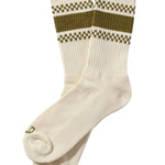 White socks with green and brown checkered patterns on a beige background