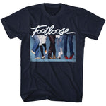 Navy blue T-Shirt featuring the Footloose logo above a lineup of dancing legs and colorful 1980s shoes