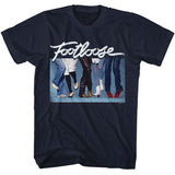 Navy blue T-Shirt featuring the Footloose logo above a lineup of dancing legs and colorful 1980s shoes