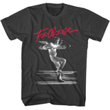 Black T-shirt featuring the red Footloose logo above a black-and-white dance scene image.