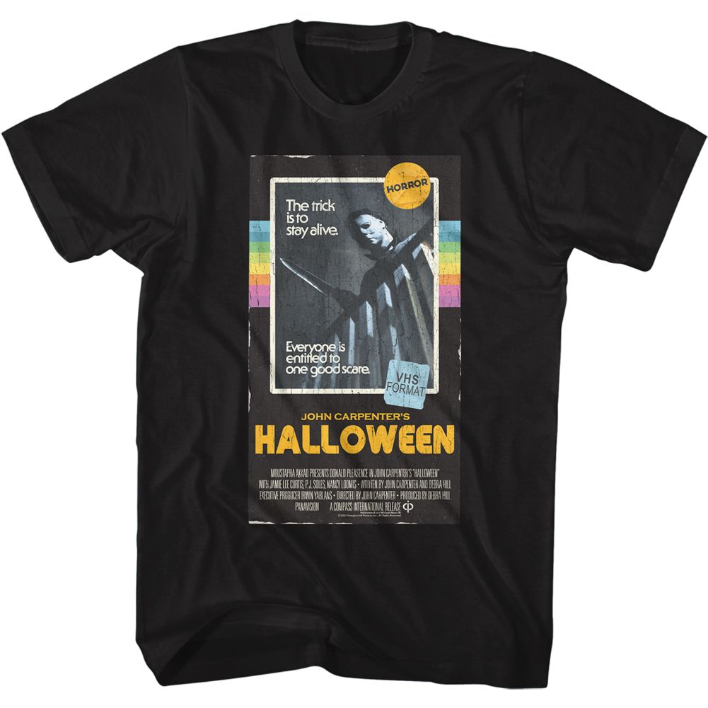 Black T-shirt featuring a vintage VHS-style design of John Carpenter’s Halloween with Michael Myers and the tagline “The trick is to stay alive.”