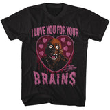 Black graphic t-shirt featuring a dripping pink heart with a classic zombie face and text reading “I Love You For Your Brains” inspired by Return of the Living Dead.