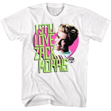 White graphic t-shirt featuring Zack Morris smiling inside a pink heart with neon green text reading “I Still Love Zack Morris” and Saved by the Bell logo.