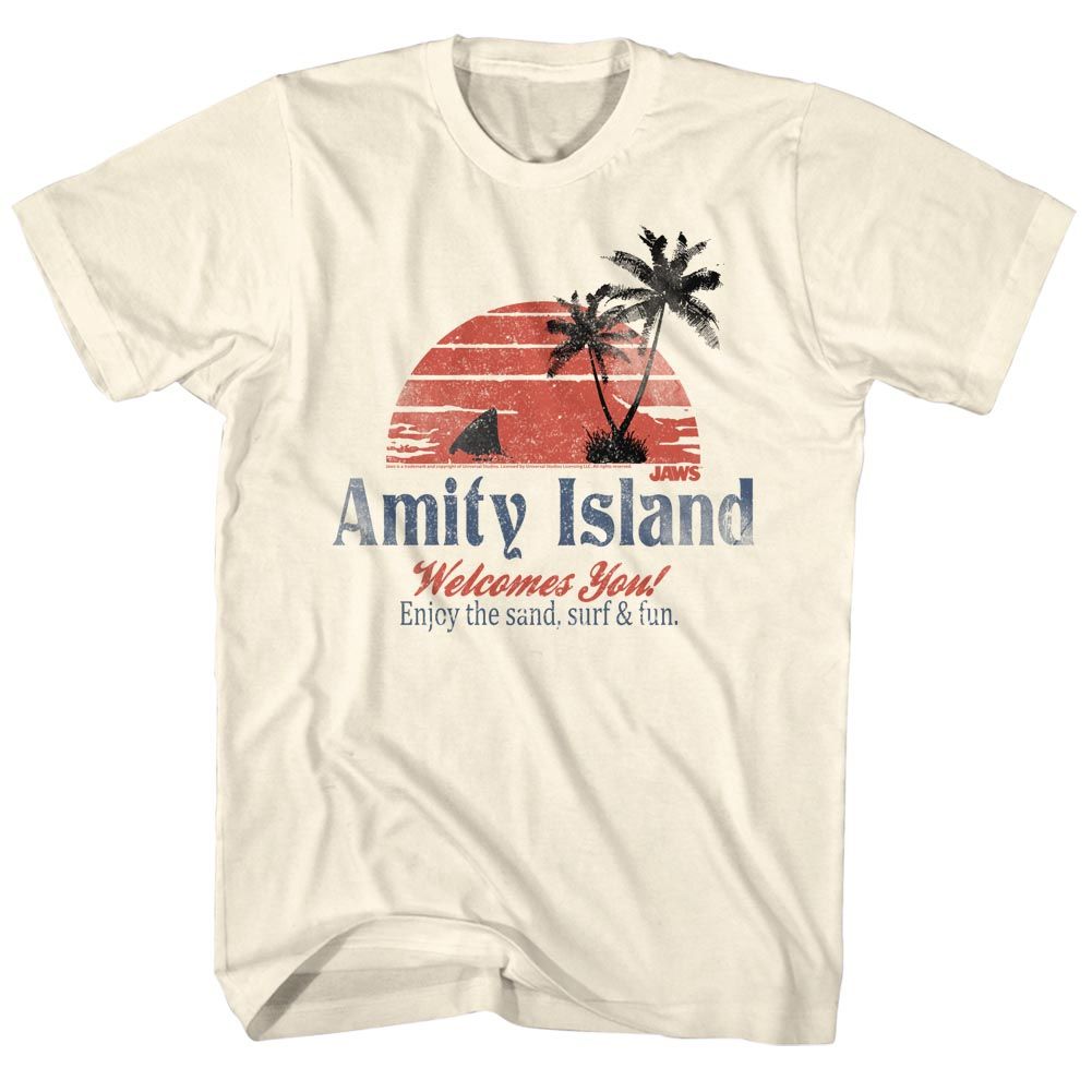 Cream-colored Jaws T-Shirt featuring a vintage Amity Island beach welcome sign with sunset, palm trees, and shark fin graphic