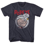 Heather navy T-shirt featuring a vintage-style illustration of Popeye inside a circular frame with a speech bubble saying “I y’am what I y’am” and bold red “POPEYE” text above.