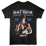 Black T-shirt featuring Rocky Balboa from Rocky IV wrapping his hands, with “1985” and “Rocky Balboa” text in blue and white.
