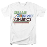 Sesame Street Athletics T-shirt featuring Cookie Monster pole vaulting with retro stripes on a white shirt