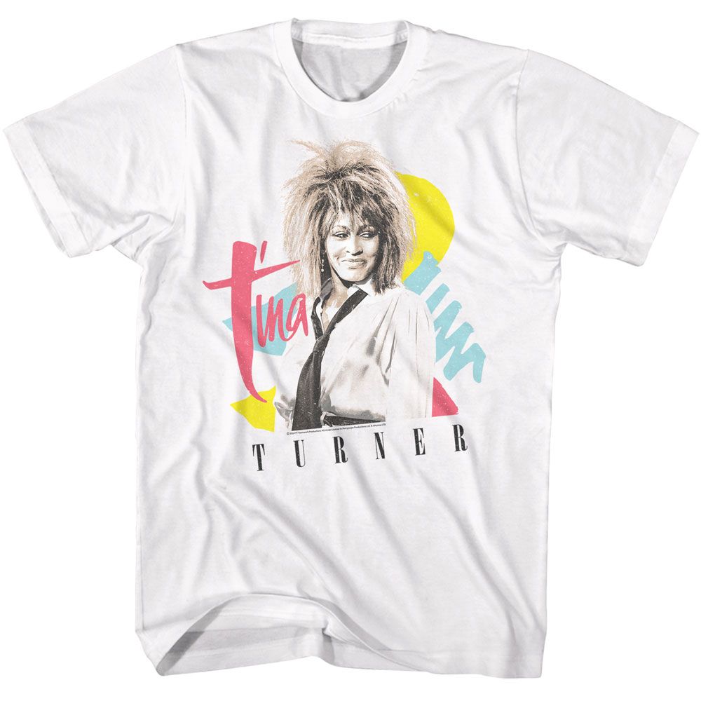 White T-shirt featuring Tina Turner with her iconic 1980s hairstyle, set against a colorful geometric background of pink, yellow, and blue shapes.